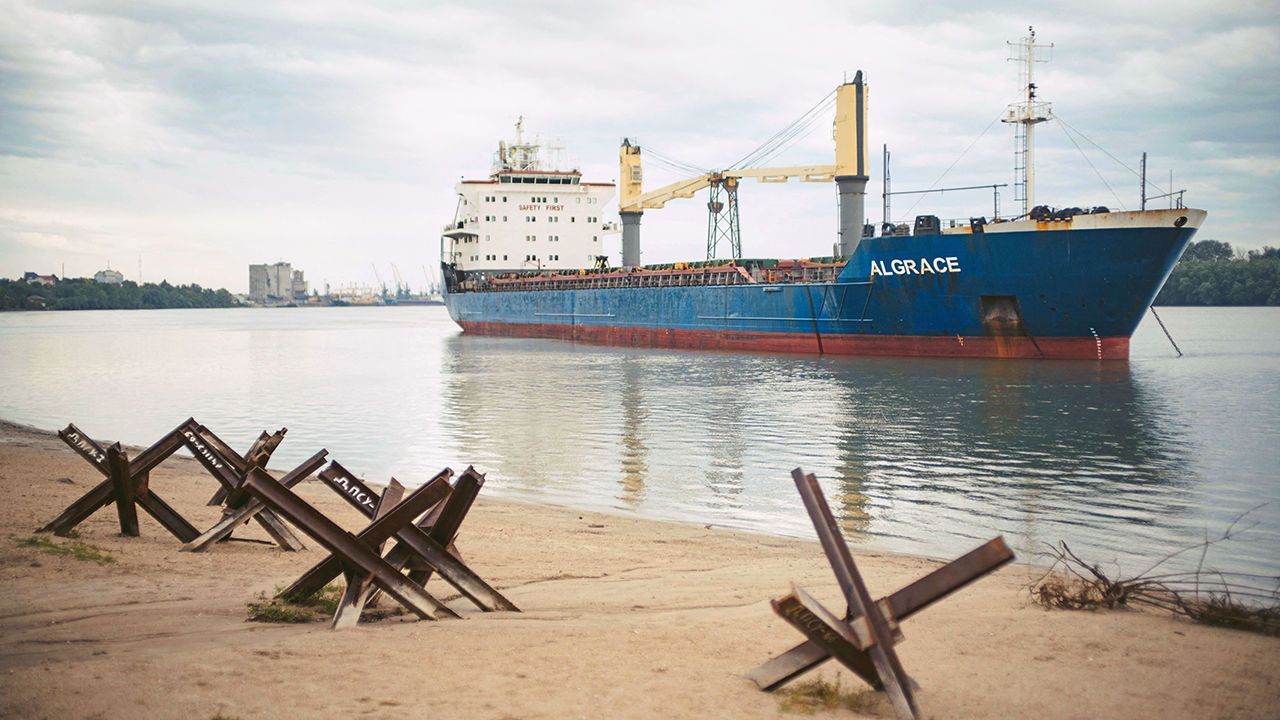 A cargo ship on the Danube river, near Izmail, Ukraine, with anti-tank defences on the river banks