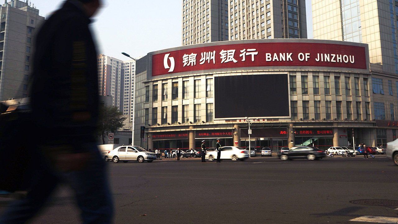 A pedestrian walks past a branch of Bank of Jinzhou in Tianjin, China.