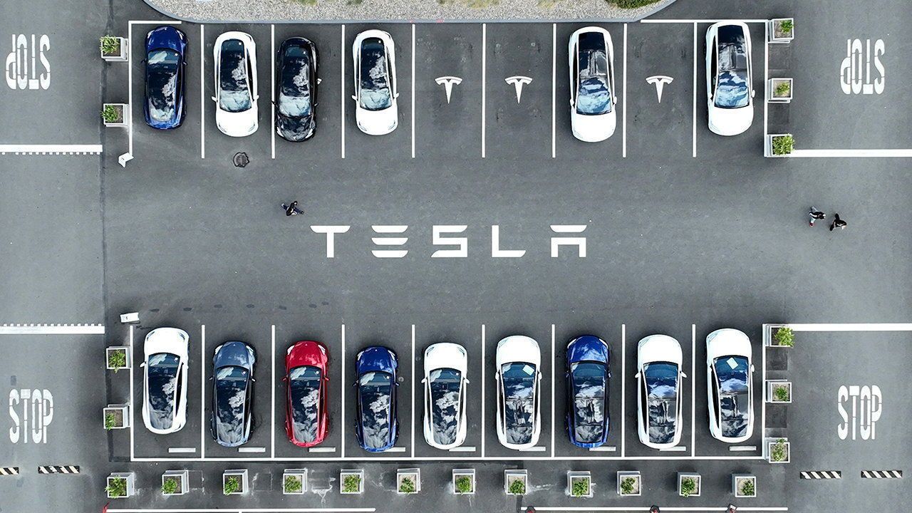 Tesla cars sit parked in a lot at the Tesla factory on April 20, 2022 in Fremont, California.